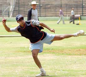 Mohammad Kaif gets ready to throw the ball while coach Greg Chappell looks on