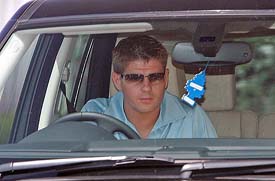 English soccer star and Liverpool captain Steven Gerrard drives out of Melwood training ground after signing a new contract with the club on Friday