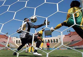 Jamaican goalkeeper Donovan Ricketts fails to stop a shot by Lungisani Ndlela of South Africa as defender Robert Scarlett (right) looks on during their CONCACAF Gold Cup soccer match in Los Angeles on Sunday