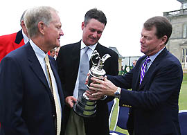 Previous winners of the British Open  Jack Nicklaus, Todd Hamilton and Tom Watson of the USA examine the Claret Jug trophy in front of the Old Course clubhouse at St Andrews, Scotland, on Tuesday