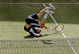 Guillermo Coria of Argentina drops his racquet as he rolls over on court during a practice session before the Davis Cup quarterfinal tie against Australia in Sydney on Wednesday. Coria will face Lleyton Hewitt in the first match on Friday.