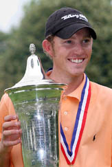 Clay Ogden of the USA holds the trophy after wining the 