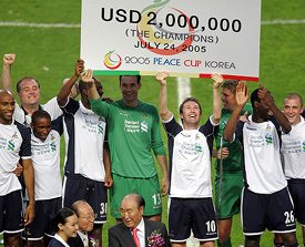 Players of British soccer club Tottenham Hotspur celebrate after winning the Peace Cup in Seoul on Sunday