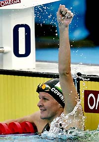 Zimbabwe�s Kirsty Coventry celebrates her victory in the women�s 100m backstroke at the World Aquatic Championships in Montreal on Tuesday