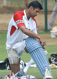 Indian captain Rahul Dravid ties a pad during a net practice session in Dambulla 