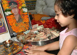 A child pays tributes to Major Kapil Vinayak during the past rites� ceremony performed at Geeta Mandir in Jalandhar on Monday.