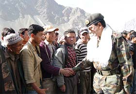 Lieut-Gen Hari Prasad shakes hands with villagers of Kargil during the inauguration of the Major Vivek Gupta Medical Aid Centre at Khumbathang in Kargil