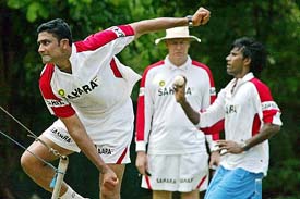 Coach Greg Chappell watches Anil Kumble and Laxmipathy Balaji bowl during a practice session in Colombo on Friday