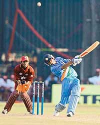 Mohammad Kaif plays a shot as West Indies wicketkeeper Denesh Ramdin looks on during the tri-series match at the R. Premadasa Stadium