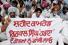 Members of the CPI hold a dharna near the residence of Punjab Panchayat Minister Lal Singh in support of their demand in Patiala on Monday.