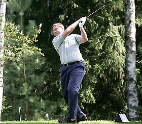Former world number one tennis player Yevgeny Kafelnikov hits a shot during a game for VIP players ahead of the Russian Open at the Moscow Country Club 