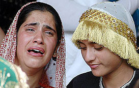 A lady cries after a grenade exploded outside Bakshi Stadium where she and others were waiting to perform during Independence Day celebrations in Srinagar, on Monday.