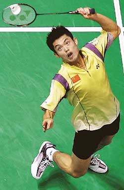 World number one Lin Dan of China executes a smash against Kennevic Asuncion of the Philippines in the second round of the IBF World Badminton Championships