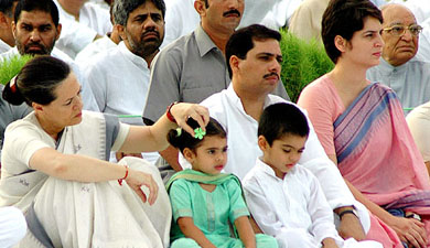 Congress President Sonia Gandhi adjusts the clip of her granddaughter while Priyanka Gandhi Vadra and Robert Vadra look on at the 61st birth anniversary of Rajiv Gandhi at Veer Bhumi in New Delhi on Saturday