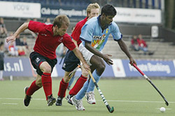 Two England players battle for the ball with India�s Ignace Tirkey (right) during the 7th-8th place playoff match at the Rabobank hockey tournament in Amstelveen on Saturday. 