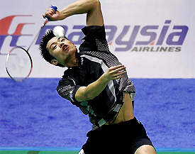 China's Lin Dan hits a smash to Denmark's Peter Gade 