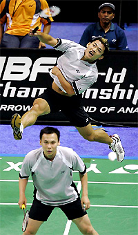 Howard Bach of the USA hits a return shot as team-mate Tony Gunawan looks on