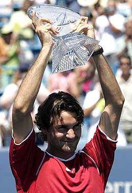 Roger Federer of Switzerland holds the trophy after defeating Andy Roddick of the USA in the final of the Cincinnati Masters 