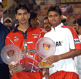 Air India captain Suresh Raina holds the Bradman Twenty20 Cup along side his teammate Naman Ojha