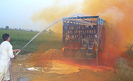A fireman throws water on acid leaking from a truck in Karnal on Friday morning.