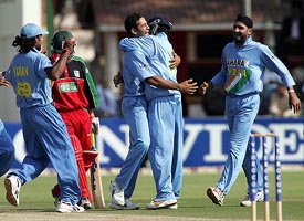 Indian pacer Irfan Pathan celebrates with team-mates after dismissing Zimbabwe batsman Gavin Ewing during a tri-series match at the Harare Sports Club