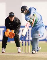 Indian batsman Mohammad Kaif plays a shot as New Zealand wicketkeeper Brendon McCullum looks on during a tri-series match at the Harare Sports Club