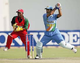 India's Mahendra Dhoni cuts a delivery past Zimbabwean wicketkeeper Tatenda Taibu at the Harare Sports Club in Zimbabwe on Sunday