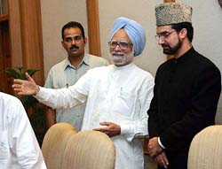 Prime Minister Manmohan Singh gestures as he talks with Mirwaiz Umar Farooq, head of the All-Party Hurriyat Conference, in New Delhi on Monday.