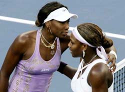 Venus Williams of the USA hugs her sister Serena after their fourth round match at the US Open in New York on Sunday