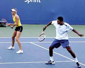 Mahesh Bhupathi and his mixed doubles partner Daniela Hantuchova of Slovakia in action against Ai Sugiyama of 