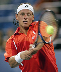 David Nalbandian of Argentina hits a return shot to Davide Sanguinetti of Italy