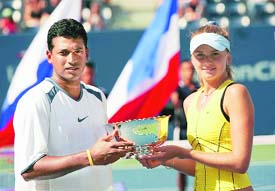 India�s Mahesh Bhupathi and Daniela Hantuchova of Slovakia hold the winners trophy after defeating Katarina Srebotnik of Slovenia and Nenad Zimonjic of Serbia & Montenegro in the mixed doubles final at the US Open in New York on Thursday. 
