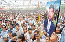 Jats carry a portrait of Baljeet, who was allegedly killed by Dalits, during a sarvkhap panchayat at Gharwal village in Sonepat on Friday