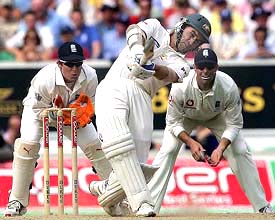 Australia�s Justin Langer hits a six as England�s Geraint Jones and Marcus Trescothick look on 
