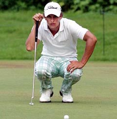Adam Scott of Australia lines up his putt on the 11th green during the Singapore Open at the Sentosa Golf Club on Saturday