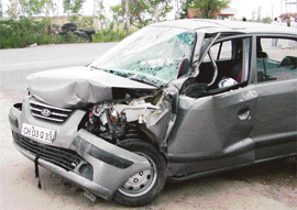 The Santro car that was damaged after it collided with a tipper parked on the Patiala-Rajpura highway on Monday morning.