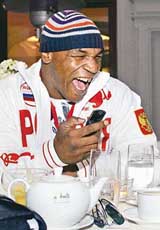 Former world boxing champion Mike Tyson of the USA wears the new Russian uniform for the 2006 Winter Olympics, to be held in Turin, during a presentation ceremony in Moscow