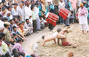 A wrestling bout in progress on the concluding day of the Sair Fair at Arki, near Shimla on Saturday