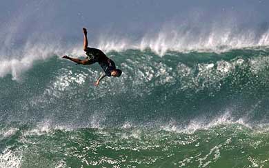 An unidentified surfer wipes out on a wave during a training session in the south-west coast of France on Monday