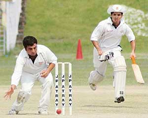 A fielder of the FCI tries to run out a PCC batsman during their match at the Sector 16 Cricket Stadium in Chandigarh on Tuesday