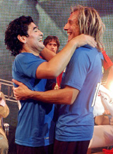 Argentine soccer legend Diego Maradona embraces former team-mate Claudio Caniggia, during Maradona's weekly television show La noche del 10