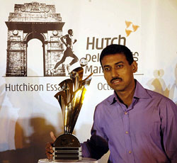 Olympic silver medallist Rajyavardhan Singh Rathore holds the Delhi Half Marathon trophy, which he unveiled in the Capital on Thursday