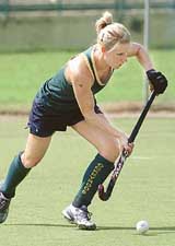Australian women's hockey team captain Nikki Hudson dribbles the ball as she takes part in a practice session at The National Stadium in New Delhi on Friday