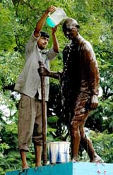 Mahatma Gandhi’s statue is washed on the eve of his 136th birth anniversary in Agartala, capital of Tripura, on Saturday