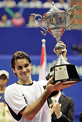 Roger Federer of Switzerland poses with the trophy after winning the Thailand Open in Bangkok on Sunday