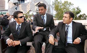 Members of the ICC World XI cricket team Rahul Dravid, Muttiah Muralitharan of Sri Lanka (centre) and Virender Sehwag in front of thousands of fans gathered in Melbourne's Federation Square