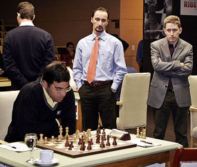 Viswanathan Anand studies the board while being watched by Michael Adams of Great Britain and Vaselin Topalov of Bulgaria during the fifth round of the World Chess Championship in San Luis on Monday