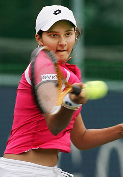 Sania Mirza hits a return to Aiko Nakamura of Japan in the second round of the Japan Open in Tokyo on Thursday