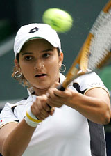 India's Sania Mirza hits a return against Vera Zvonareva of Russia during their quaterfinal match at the Japan Open in Tokyo on Friday