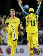Australia�s Brett Lee rejoices with team-mate Adam Gilchrist after taking the wicket of World XI player Virender Sehwag